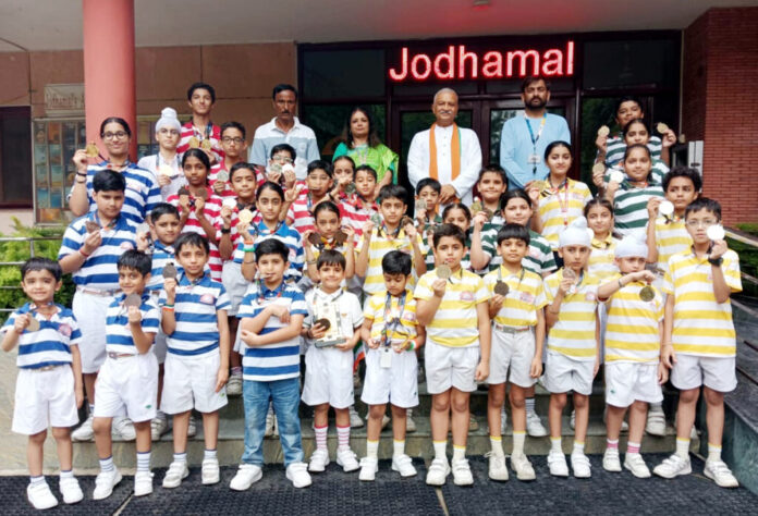 Jodhamal Public School students celebrate winning medals in roller skating.